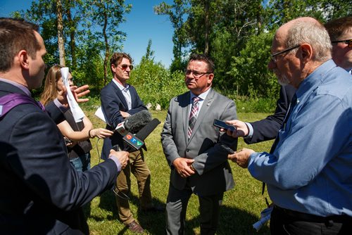 MIKE DEAL / WINNIPEG FREE PRESS
Jeff Wharton Minister of Municipal Relations talks to reporters after Premier Brian Pallister and Jim Carr, Federal Minister of Natural Resources Canada, announced a $540 million infrastructure project for flood management of the Lake Manitoba and Lake St. Martin outlet channels at an event at Parc Gros Arbre, off Allard Road close to St. Laurent, Manitoba, Monday morning.
180618 - Monday, June 18, 2018.