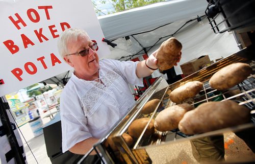 PHIL HOSSACK / WINNIPEG FREE PRESS -Calvin Patching loads his custom oven with potatoes he hopes he can sell to overbaked patrons at the Red River Ex Tuesday afternoon. See Maggie Macintosh's story.- June 19, 2018