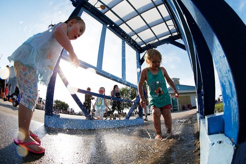 JOHN WOODS / WINNIPEG FREE PRESS
Emily Strong, 2, left, and Kirsten Davis, 3 cool down as they play in a water spray station at The Ex in Winnipeg Tuesday, June 19, 2018. The Ex is expecting great weather this year and even better attendance.