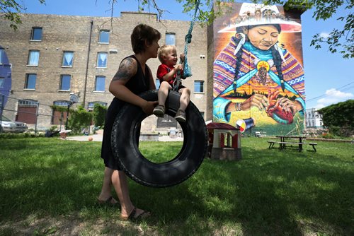 RUTH BONNEVILLE / WINNIPEG FREE PRESS

Photo of Vineyard residents, Amanda Leighton and her son Merrick (3yrs), playing in the church park Wednesday.  Story is how John Rademaker, the pastor of Vineyard Church, a North Main church on Main & Sutherland, is fighting the historical designation of his church building  a former warehouse  citing the restrictions would  prevent redeveloping the fourth floor for additional transitional housing and 
eliminate the ability to paint murals on the building exterior, which he said is key to the churchs community outreach.

Aldo Santin
City Hall Reporter

June 20, 2018
