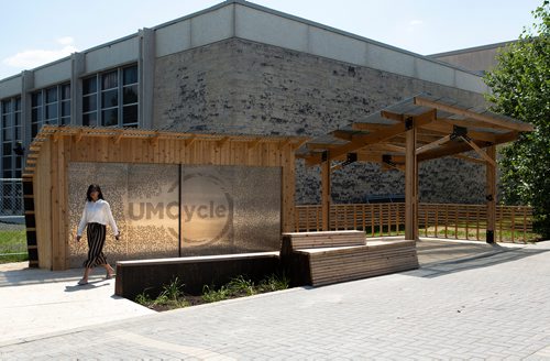 ANDREW RYAN / WINNIPEG FREE PRESS A woman walks passed the newly built UMCycle storage for the encamps bicycle repair shop on June 20, 2018.