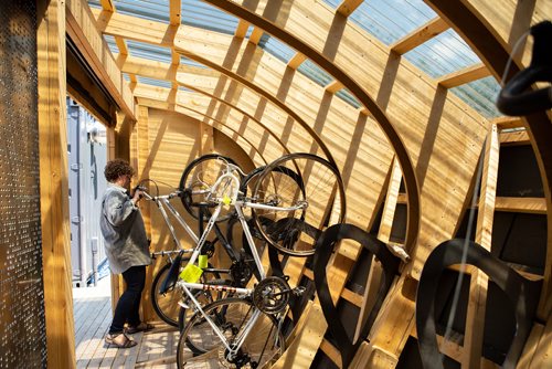 ANDREW RYAN / WINNIPEG FREE PRESS Anna Weier parks a bicycle in the newly built UMCycle parking shed on the University of Manitoba campus June 20, 2018.