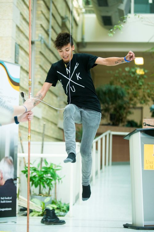 MIKAELA MACKENZIE / WINNIPEG FREE PRESS
Inuk Maxine Angoo demonstrates one of three high-kick Inuit games at Indigenous Peoples Day festivities at the University of Manitoba Bannatyne campus in Winnipeg on Thursday, June 21, 2018. 
Mikaela MacKenzie / Winnipeg Free Press 2018.