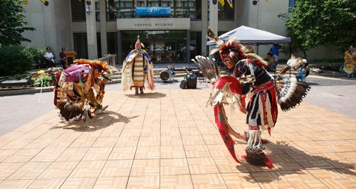 MIKE DEAL / WINNIPEG FREE PRESS
Stacey Kiyewakan (right) and his father Dean Kiyewakan (left) dance with  Rhonda James (centre) during a celebration of National Indigenous Peoples Day at the City Hall courtyard Thursday afternoon. National Indigenous Peoples Day recognizes and honours the cultures of First Nations, Metis and Inuit peoples.
180621 - Thursday, June 21, 2018.