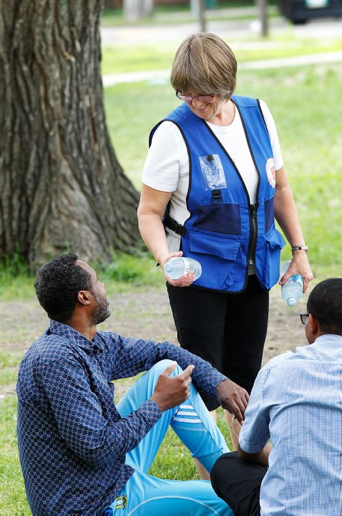 PHIL HOSSACK / WINNIPEG FREE PRESS -  Debbie Clarke, Salvation Army's Emergency Disaster Services Director for Manitoba and NW Ontario passes out bottles of cold water at Central Park Thursday afternoon. Temeratures soared to 30C and more in the inner city. She says her unit doled out nearly 500 bottles on the way to and at the park. See release. - June 21, 2018