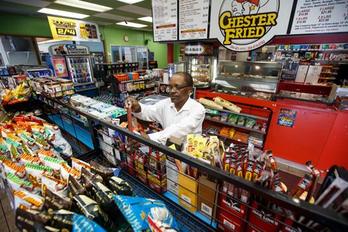 MIKE DEAL / WINNIPEG FREE PRESS
Degu Awegachew organizing stock at Buntys convenience store which is owned by his son Yonas Zewude.
180622 - Friday, June 22, 2018.