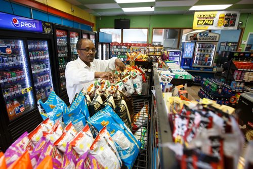 MIKE DEAL / WINNIPEG FREE PRESS
Degu Awegachew organizing stock at Buntys convenience store which is owned by his son Yonas Zewude.
180622 - Friday, June 22, 2018.