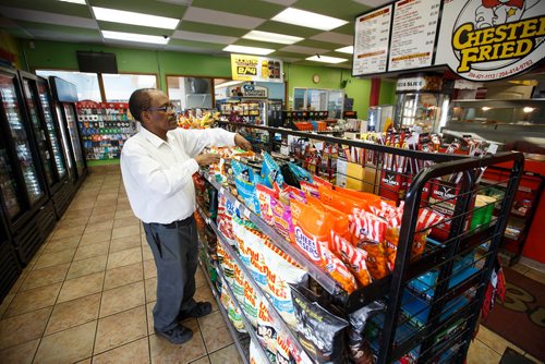 MIKE DEAL / WINNIPEG FREE PRESS
Degu Awegachew organizing stock at Buntys convenience store which is owned by his son Yonas Zewude.
180622 - Friday, June 22, 2018.