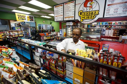 MIKE DEAL / WINNIPEG FREE PRESS
Degu Awegachew organizing stock at Buntys convenience store which is owned by his son Yonas Zewude.
180622 - Friday, June 22, 2018.