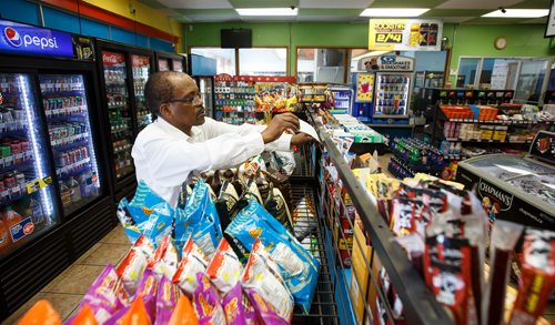 MIKE DEAL / WINNIPEG FREE PRESS
Degu Awegachew organizing stock at Buntys convenience store which is owned by his son Yonas Zewude.
180622 - Friday, June 22, 2018.