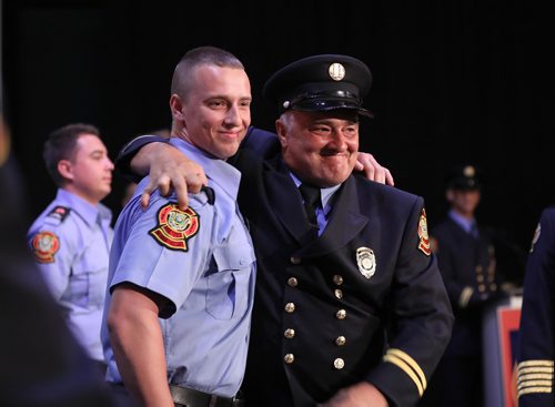 RUTH BONNEVILLE / WINNIPEG FREE PRESS

Fire Chief Mike Siemens who's been a firefighter for 34 years, smiles proudly as he gives his son, Macauley Siemens, a hug after pinning on his badge at his graduation ceremony atThe Metropolitan Entertainment Centre Friday.   
Siemens was one of 15  graduates with recruit Class #1802 to graduate from Winnipeg Fire Paramedic Services 10-week orientation and training period Friday.  


June 22, 2018

