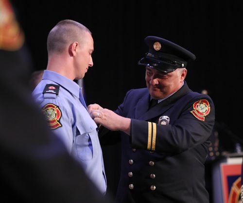 RUTH BONNEVILLE / WINNIPEG FREE PRESS

Fire Chief Mike Siemens who's been a firefighter for 34 years, pins a badge onto his son Macauley Siemens,  at his graduation ceremony atThe Metropolitan Entertainment Centre Friday.   
Siemens was one of 15  graduates with recruit Class #1802 to graduate from Winnipeg Fire Paramedic Services 10-week orientation and training period Friday.  


June 22, 2018
