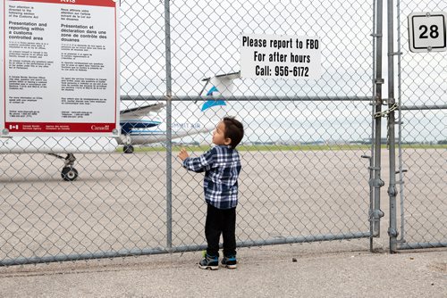 ANDREW RYAN / WINNIPEG FREE PRESS Linden Gurniak looks out onto the tarmac towards the planes that are taking residents of Little Grand Rapids home. Residents are finally heading back home after being evacuated from their community due to dangerous wild fires.