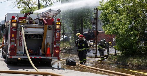 MIKE DEAL / WINNIPEG FREE PRESS
Winnipeg Fire Paramedic Service crews work on putting out a fire in the yard of Orloff Scrap Metals located at King Street and Sutherland Avenue.
180625 - Monday, June 25, 2018.