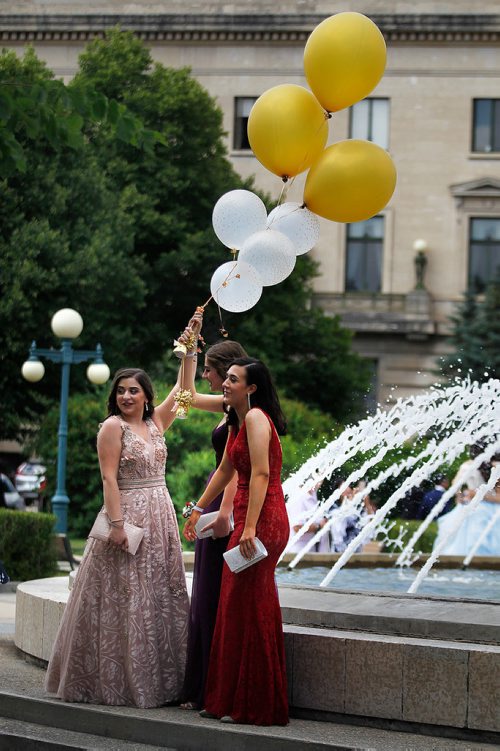 PHIL HOSSACK / WINNIPEG FREE PRESS -  Left to right, Christina DeLucas, Chloe Belanger and Lissandra D'Ottavio pose with a propp of balloons. Lenscaps flew, Students struck a pose and camera's clicked at the Legislative Grounds Monday as groups of Graduating High School Students showed up to use the fountain and stairs as a backdropp for photos. See Jen's story.  - June 25, 2018