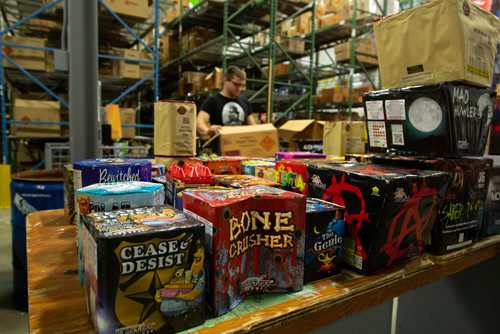 ANDREW RYAN / WINNIPEG FREE PRESS Cole Salter packages a summer themed assortment of fireworks at Red Bomb Fireworks in Selkirk on June 26, 2018.