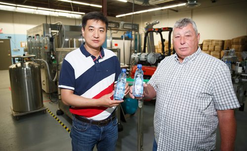 MIKE DEAL / WINNIPEG FREE PRESS
Fledgling company Eautopia Biological Technology Inc. owned by John Fu (left) with president Rene Lamoureux (right) in their new bottling facility on Airport Road.
180627 - Wednesday, June 27, 2018.