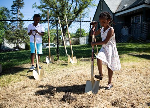 ANDREW RYAN / WINNIPEG FREE PRESS Deborah Haile, and her brother Yoel break ground on their new home's foundation in St. Boniface on June 27, 2018. The project marks the first time Habitat for Humanity has acquired land in the area in six years.