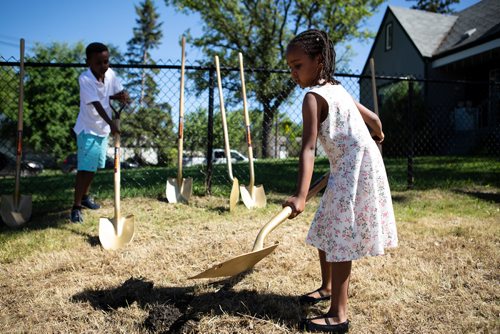 ANDREW RYAN / WINNIPEG FREE PRESS Deborah Haile, and her brother Yoel break ground on their new home's foundation in St. Boniface on June 27, 2018. The project marks the first time Habitat for Humanity has acquired land in the area in six years.