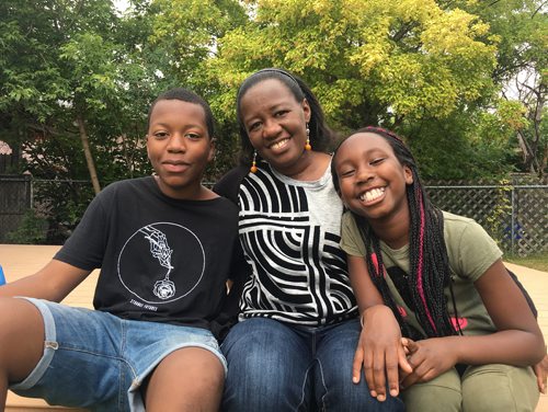 MAGGIE MACINTOSH / WINNIPEG FREE PRESS
Lamine Bah, left, and his little sister Aïcha Bah, far right, have gone to St. Malo Catholic Camp for the last two years thanks to a Sunshine Fund subsidy. His mom, pictured in the middle, said she really appreciates the financial aid. June 27, 2018