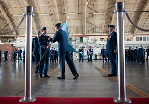 ANDREW RYAN / WINNIPEG FREE PRESS Brigadier General David Cochrane passes the 17 Wing Squadron Flag to Colonel J.P.E. Charron during the change of command ceremony on June 28, 2018.