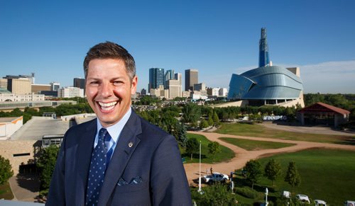 MIKE DEAL / WINNIPEG FREE PRESS
Winnipeg Mayor Brian Bowman on the roof of The Inn at The Forks with the skyline of the city behind him.
180628 - Thursday, June 28, 2018.