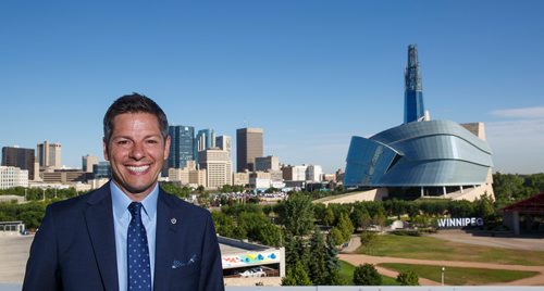 MIKE DEAL / WINNIPEG FREE PRESS
Winnipeg Mayor Brian Bowman on the roof of The Inn at The Forks with the skyline of the city behind him.
180628 - Thursday, June 28, 2018.