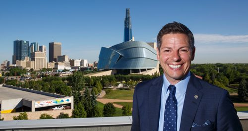 MIKE DEAL / WINNIPEG FREE PRESS
Winnipeg Mayor Brian Bowman on the roof of The Inn at The Forks with the skyline of the city behind him.
180628 - Thursday, June 28, 2018.