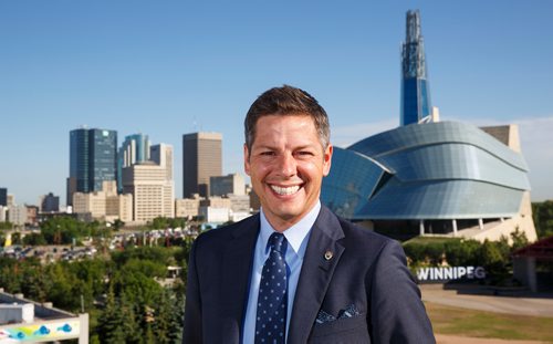 MIKE DEAL / WINNIPEG FREE PRESS
Winnipeg Mayor Brian Bowman on the roof of The Inn at The Forks with the skyline of the city behind him.
180628 - Thursday, June 28, 2018.