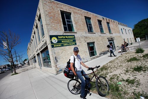 PHIL HOSSACK / WINNIPEG FREE PRESS - Riding his bike in for supplies, Warren Catcheway was taken by surprise Thursday as he and other customers found out the doors close Saturday at Neechi Commons. See Maggie Macintosh story. - June 27, 2018