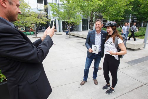 MIKE DEAL / WINNIPEG FREE PRESS
After a press event for announcing a downtown night market around the Graham Mall between Kennedy and Edmonton, Mayor Brian Bowman takes time to say hi to passersby and pose for pictures.
Carrie Bryson, 25, ran up to Mayor Brian Bowman to ask if she could have her photo taken with him while she holds a drawing she made of the musician Drake. Drake released a new album titled Scorpion today.
180629 - Friday, June 29, 2018.