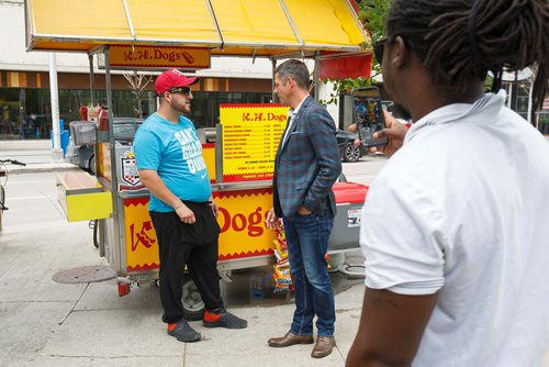 MIKE DEAL / WINNIPEG FREE PRESS
After a press event for announcing a downtown night market around the Graham Mall between Kennedy and Edmonton, Mayor Brian Bowman takes time to say hi to passersby and pose for pictures.
Mayor Brian Bowman chats with Fawaz Hadji owner of the K.H. Dogs food cart.
180629 - Friday, June 29, 2018.