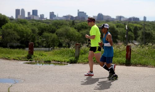 TREVOR HAGAN / WINNIPEG FREE PRESS
Dr.Michael Ellery runs alongside Junel Malapad as he runs 160km's up and down Garbage Hill raising awareness for Mental health in an event he has dubbed Taking Stigma to the Trash,  Friday, June 29, 2018.