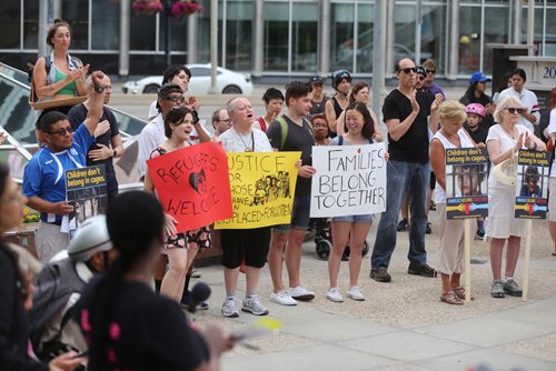 TREVOR HAGAN / WINNIPEG FREE PRESS
A group gathered in front of 201 Portage Avenue, the building that houses the U.S. Consulate to call to end family separation and immigration detention, Saturday, June 30, 2018.