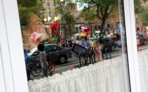 TREVOR HAGAN / WINNIPEG FREE PRESS
Someone inside Bistro Dansk looks out as Art City celebrated 20 years of programming with their annual parade, Saturday, June 30, 2018.