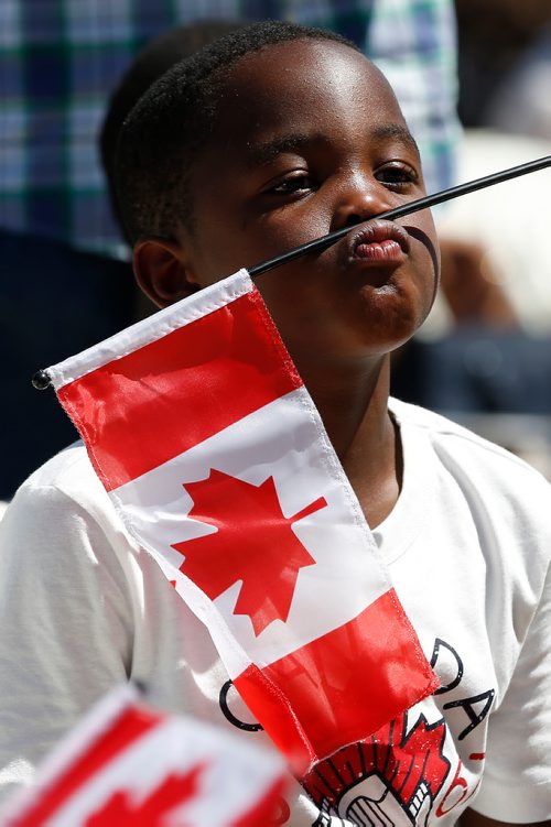 JOHN WOODS / WINNIPEG FREE PRESS
A child takes a break during a citizenship ceremony on  Canada Day at Assiniboine Park, Sunday, July 1, 2018.