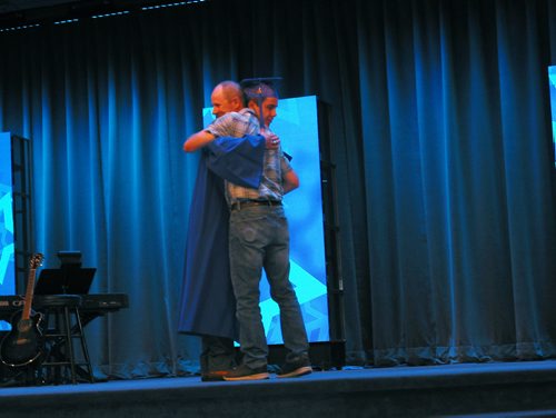 Canstar Community News June 21, 2018 - Jed Erb received a hug and one of the Derek Erb Seeds Inc. hockey scholarships at Sanford Collegiate's graduation on June 21. (ANDREA GEARY/CANSTAR COMMUNITY NEWS)