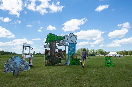 ANDREW RYAN / WINNIPEG FREE PRESS Natasha Lowenthal, puts the finishing touches on her art installation "The Prairie Booth" at Manitoba music festival Folkfest on July 4, 2018. The both functions as an interactive photo booth for festival goers.