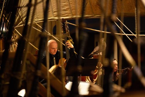 ANDREW RYAN / WINNIPEG FREE PRESS The Winnipeg Symphony Orchestra bassist Bruce Okrainec plays on the Nonsuch replica at the Manitoba Museum on July 4, 2018. The symphony was playing music themes related to water.