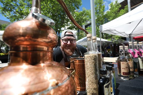 RUTH BONNEVILLE / WINNIPEG FREE PRESS
Jesse Hildebrand, Assistant General Manager with Capital K Distillery, talks to a reporter about US tariffs while working at his booth at the downtown farmers' market at Hydro Place on Thursday.
For story on the new tariffs that are on products, like whiskey, from the US.
See Ben Waldman story.
July 05, 2018