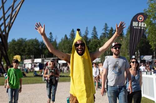 ANDREW RYAN / WINNIPEG FREE PRESS A man dressed as a banana gathers with other festival goers as they walk towards the Main Stage to welcome first performer Roger Roger who kicks off Folk Fest on July 5, 2018.