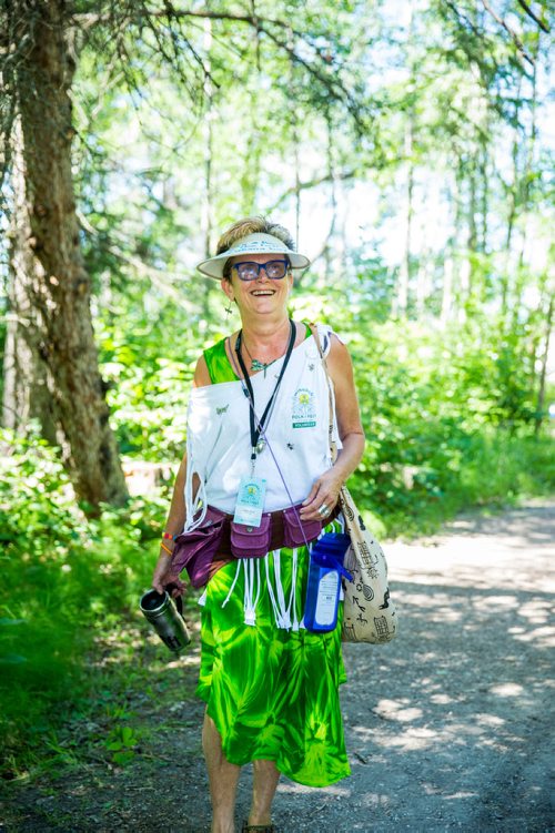 MIKAELA MACKENZIE / WINNIPEG FREE PRESS
Donna Mills, volunteer at the InfOasis, walks down a path at the Winnipeg Folk Fest in Bird's Hill Provincial Park on Friday, July 6, 2018. 
Mikaela MacKenzie / Winnipeg Free Press 2018.