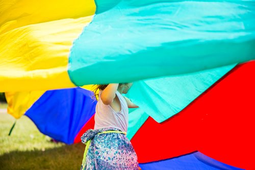 MIKAELA MACKENZIE / WINNIPEG FREE PRESS
Ennya McLaren, three, plays in the parachute at the Winnipeg Folk Fest in Bird's Hill Provincial Park on Friday, July 6, 2018. 
Mikaela MacKenzie / Winnipeg Free Press 2018.