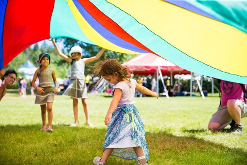 MIKAELA MACKENZIE / WINNIPEG FREE PRESS
Ennya McLaren, three, plays in the parachute at the Winnipeg Folk Fest in Bird's Hill Provincial Park on Friday, July 6, 2018. 
Mikaela MacKenzie / Winnipeg Free Press 2018.