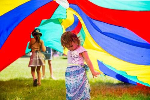 MIKAELA MACKENZIE / WINNIPEG FREE PRESS
Ennya McLaren, three, plays in the parachute at the Winnipeg Folk Fest in Bird's Hill Provincial Park on Friday, July 6, 2018. 
Mikaela MacKenzie / Winnipeg Free Press 2018.