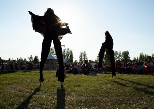 ANDREW RYAN / WINNIPEG FREE PRESS Two stilted performers walk through an area next to the main stage at Winnipeg Folk Fest in Birds Hill Provincial Park on July 6, 2018.