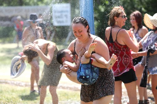 RUTH BONNEVILLE / WINNIPEG FREE PRESS


People cool themselves at a water station while attending the Winnipeg Folk Fest at Birds Hill Park Saturday.

July 07, 2018 
