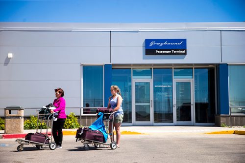 MIKAELA MACKENZIE / WINNIPEG FREE PRESS
Barbara Pawluck (left) and Wynter Payjack (12), who came from Prince George by air and are headed for Neepawa later today take a turn around the parking lot for a Global news camera at the Greyhound bus terminal in Winnipeg on Monday, July 9, 2018. Greyhound is cutting all of their prairie services this October.
Mikaela MacKenzie / Winnipeg Free Press 2018.