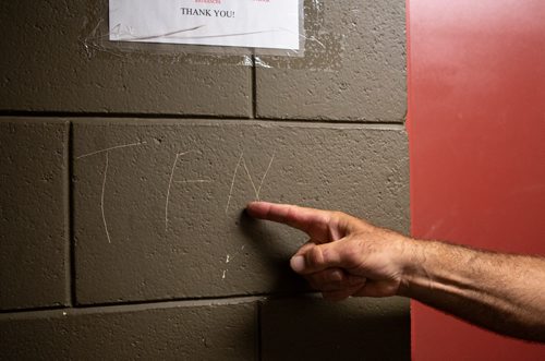 ANDREW RYAN / WINNIPEG FREE PRESS Tom Kowalsky points to markings he believes relate to gang activity in his building. Kowalsy was stabbed while helping police during a raid in his apartment building in Lord Selkirk Park. Kowalsky is frustrated at the lack of security in his building. Shot on July 11, 2018.