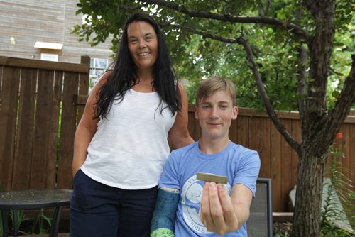 ERIK PINDERA / WINNIPEG FREE PRESS 
Candace Mitchler and son Brett May beam while May shows off the piece of metal he learned how to use to start a fire at camp. July 12, 2018